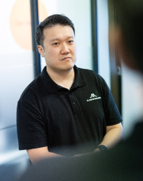 AI Advancements professional in dark shirt with arms crossed, representing the AI chatbot step of seamless integration with your website and systems